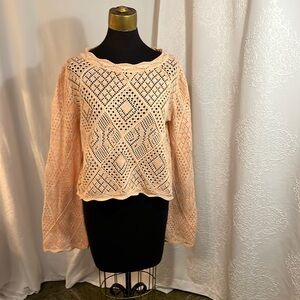 Peach crochet sweater.